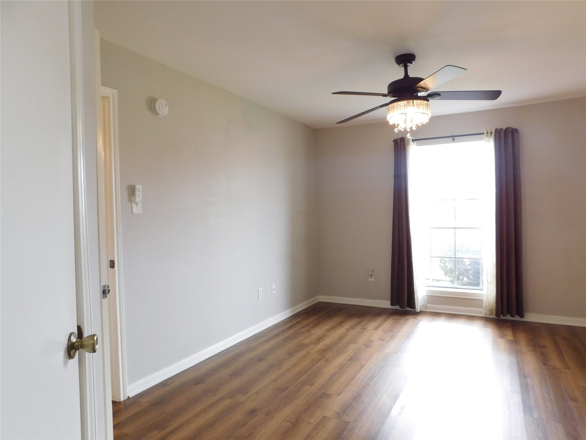 10101 South Gessner Road, Unit 912 Houston, TX 77071 - Photo 20 of 47 a view of empty room with wooden floor and fan