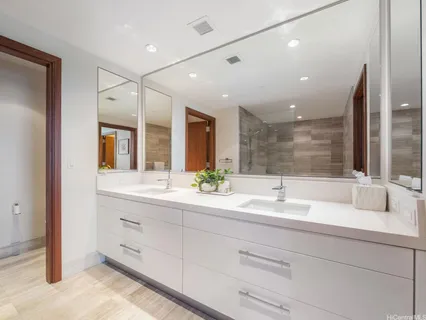 a bathroom with a double vanity sink mirror and double