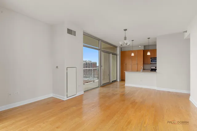 a view of a kitchen with a sink and refrigerator