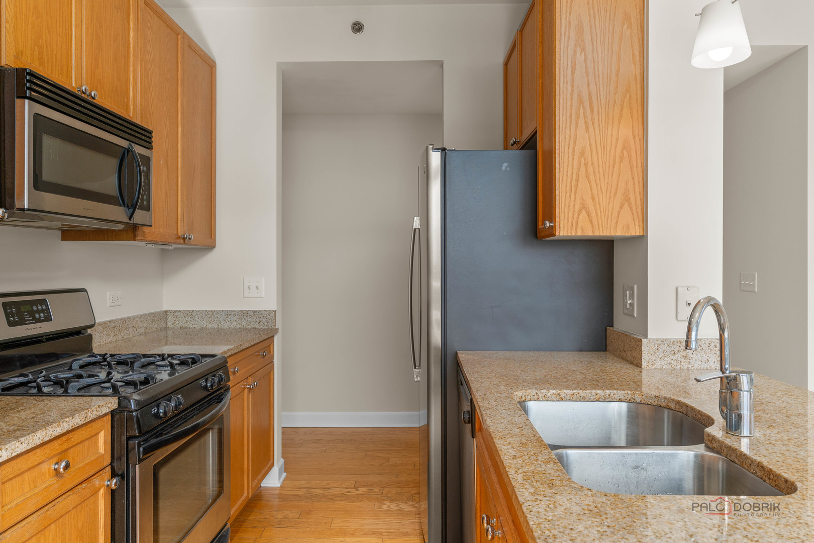 1400 South Michigan Avenue, Unit 1404 Chicago, IL 60605 - Photo 9 of 26 a kitchen with a sink and a stove top oven