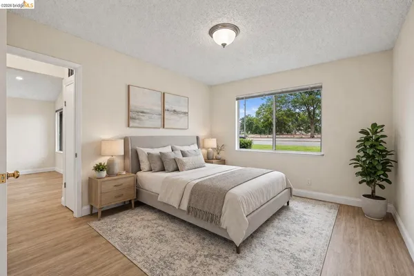 a bedroom with a bed and a potted plant