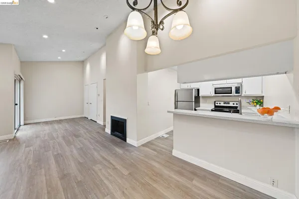 a kitchen with stainless steel appliances granite countertop a refrigerator a stove and a sink with granite countertops