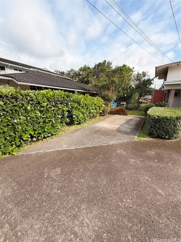 a backyard of a house with table and chairs