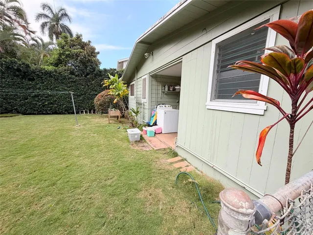 a backyard of a house with table and chairs