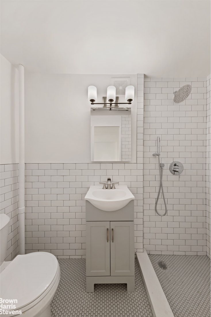 98-41 64th Road, Unit 3G Queens, NY 11374 - Photo 8 of 14 a bathroom with a sink a toilet and shower
