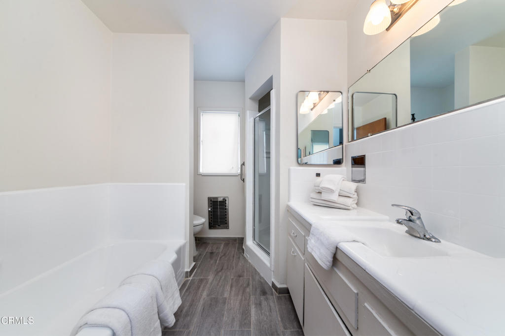 1305 Solita Road Pasadena, CA 91103 - Photo 19 of 33 a bathroom with a sink a toilet and a large mirror
