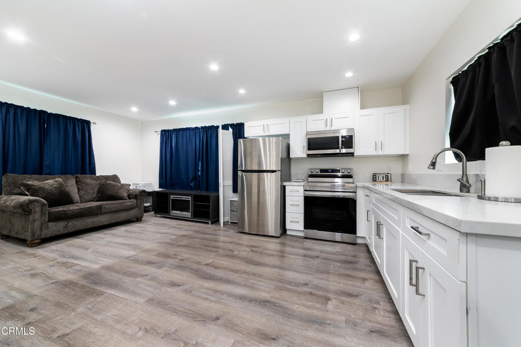 1305 Solita Road Pasadena, CA 91103 - Photo 27 of 33 a kitchen with granite countertop a refrigerator and a stove top oven