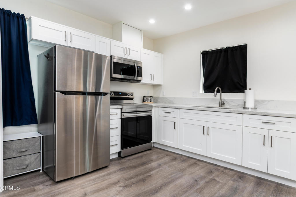 1305 Solita Road Pasadena, CA 91103 - Photo 28 of 33 a kitchen with stainless steel appliances a refrigerator microwave and sink