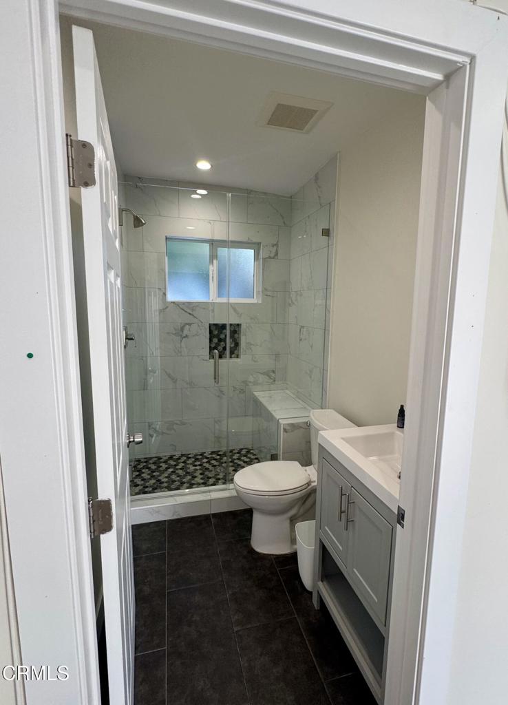 1305 Solita Road Pasadena, CA 91103 - Photo 31 of 33 a bathroom with a double vanity sink toilet and shower