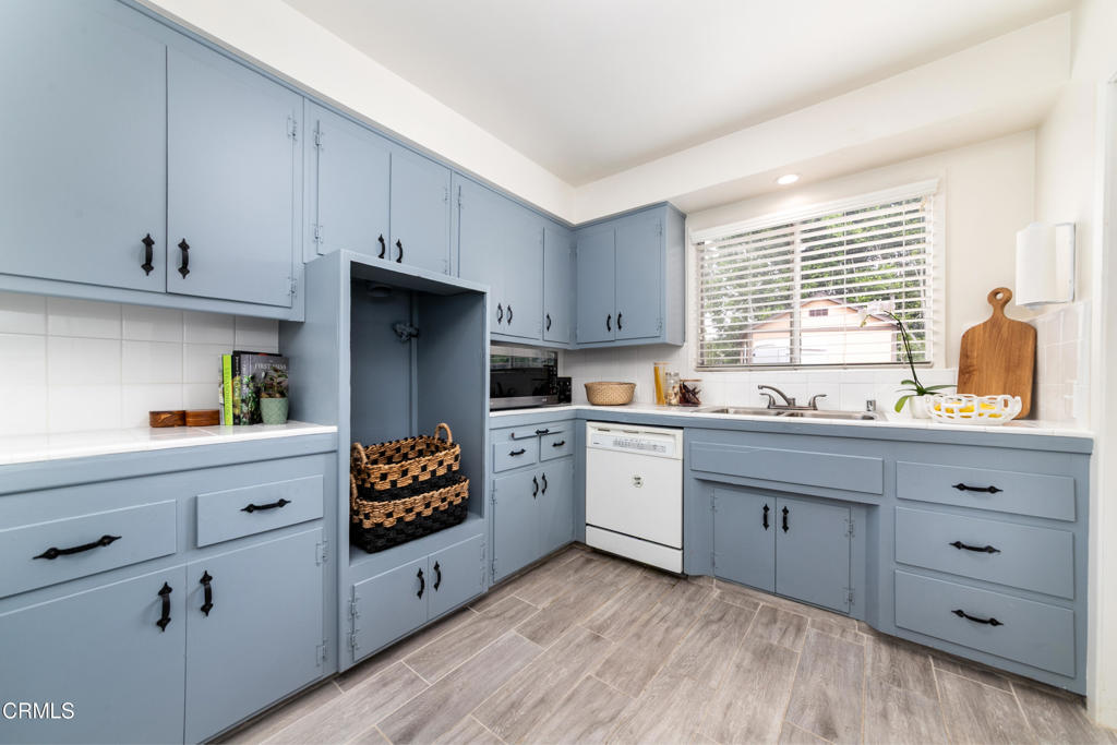 1305 Solita Road Pasadena, CA 91103 - Photo 10 of 33 a kitchen with granite countertop white cabinets and window