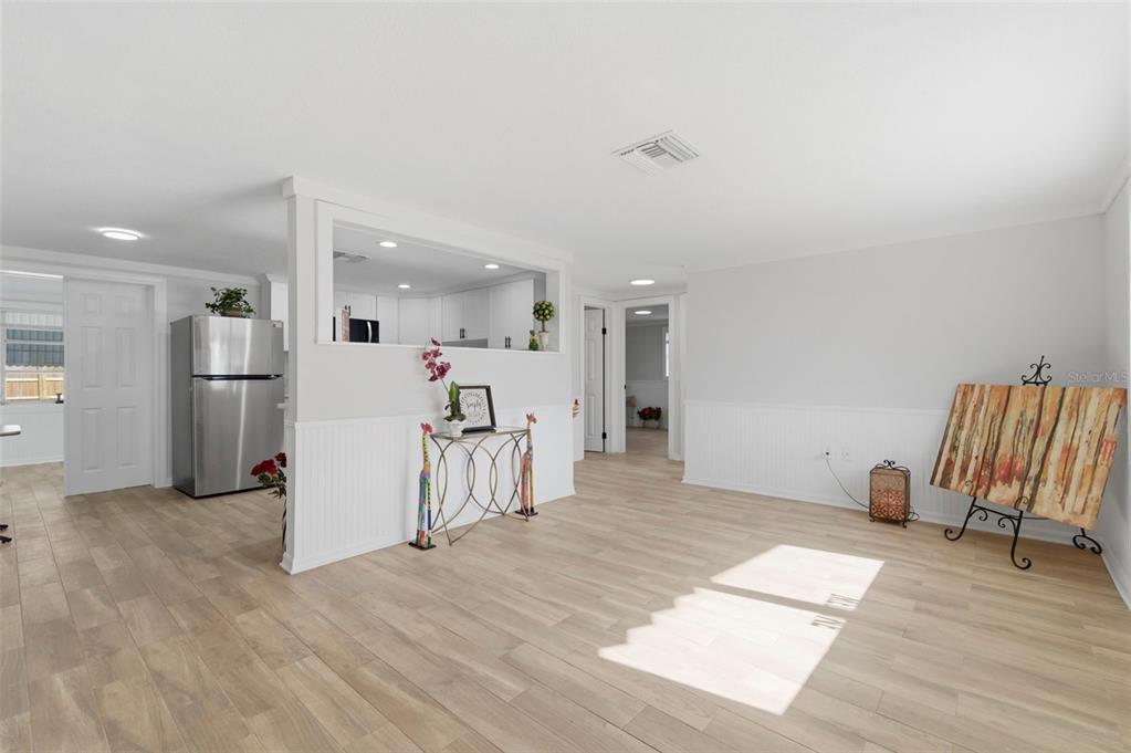 9033 Pegasus Avenue Port Richey, FL 34668 - Photo 6 of 56 a view of kitchen with furniture and a refrigerator