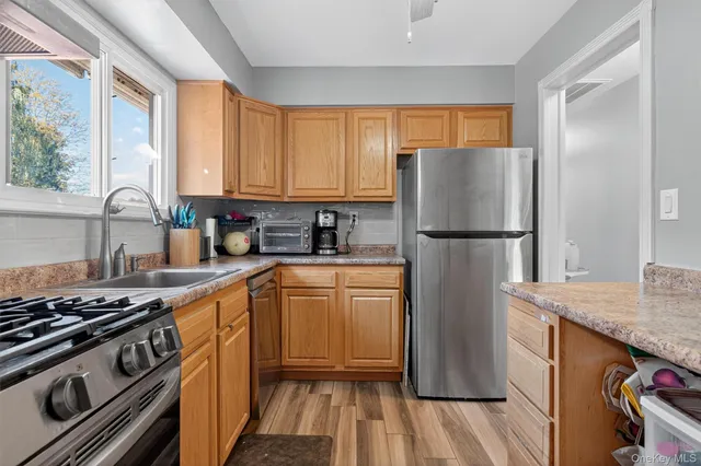 a kitchen with a refrigerator stove and sink