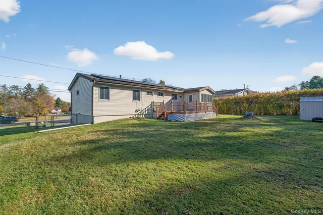 a front view of a house with a garden and trees