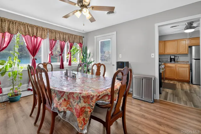 a dining room with furniture and wooden floor