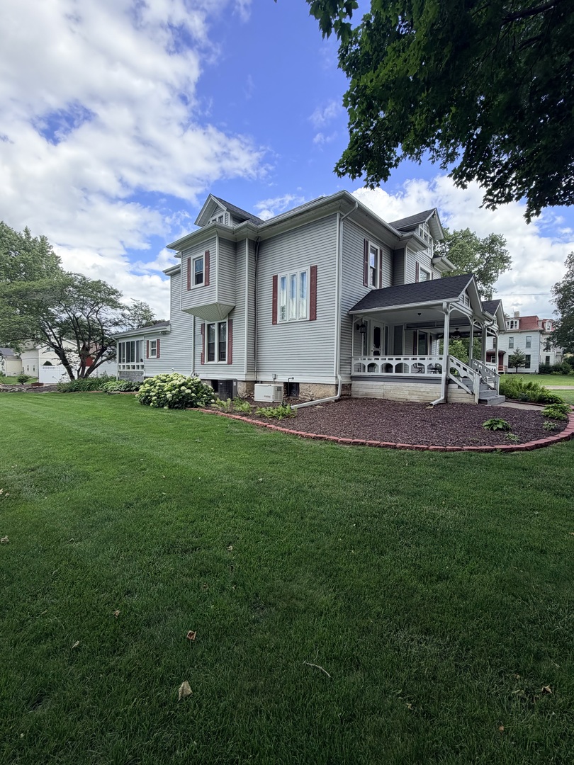 340 South Main Street Sheffield, IL 61361 - Photo 3 of 32 a front view of a house with a garden and trees