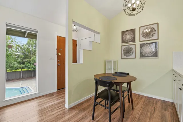 a view of a room that has a table and a chair in it