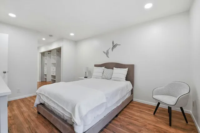 a bedroom with a bed and a chair