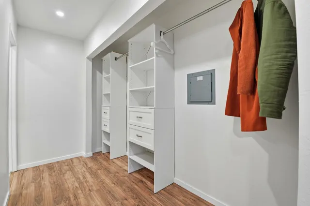 a view of walk in closet with clothes and shoes