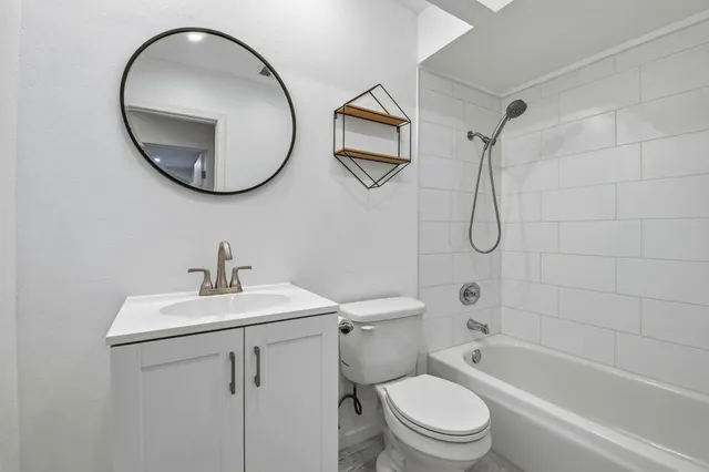 a bathroom with a sink a toilet and a mirror