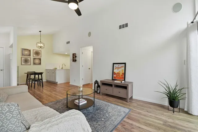 a living room with furniture and wooden floor