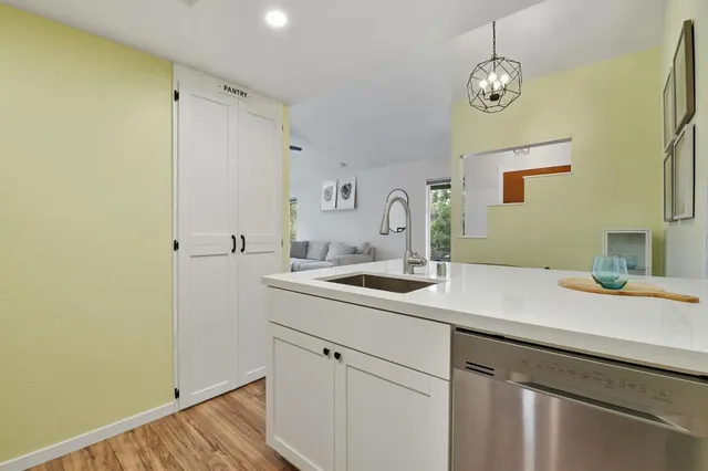 a view of a sink and wooden floor