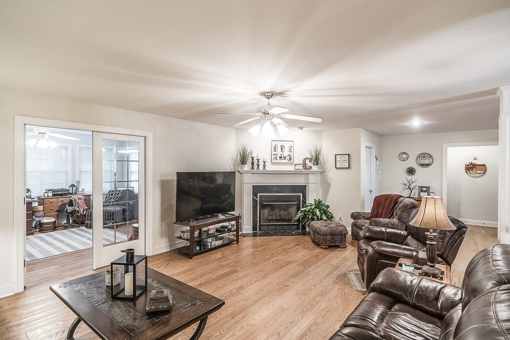 182 Calvert Ridge Road Westmoreland, TN 37186 - Photo 12 of 50 a living room with furniture a fireplace and a flat screen tv