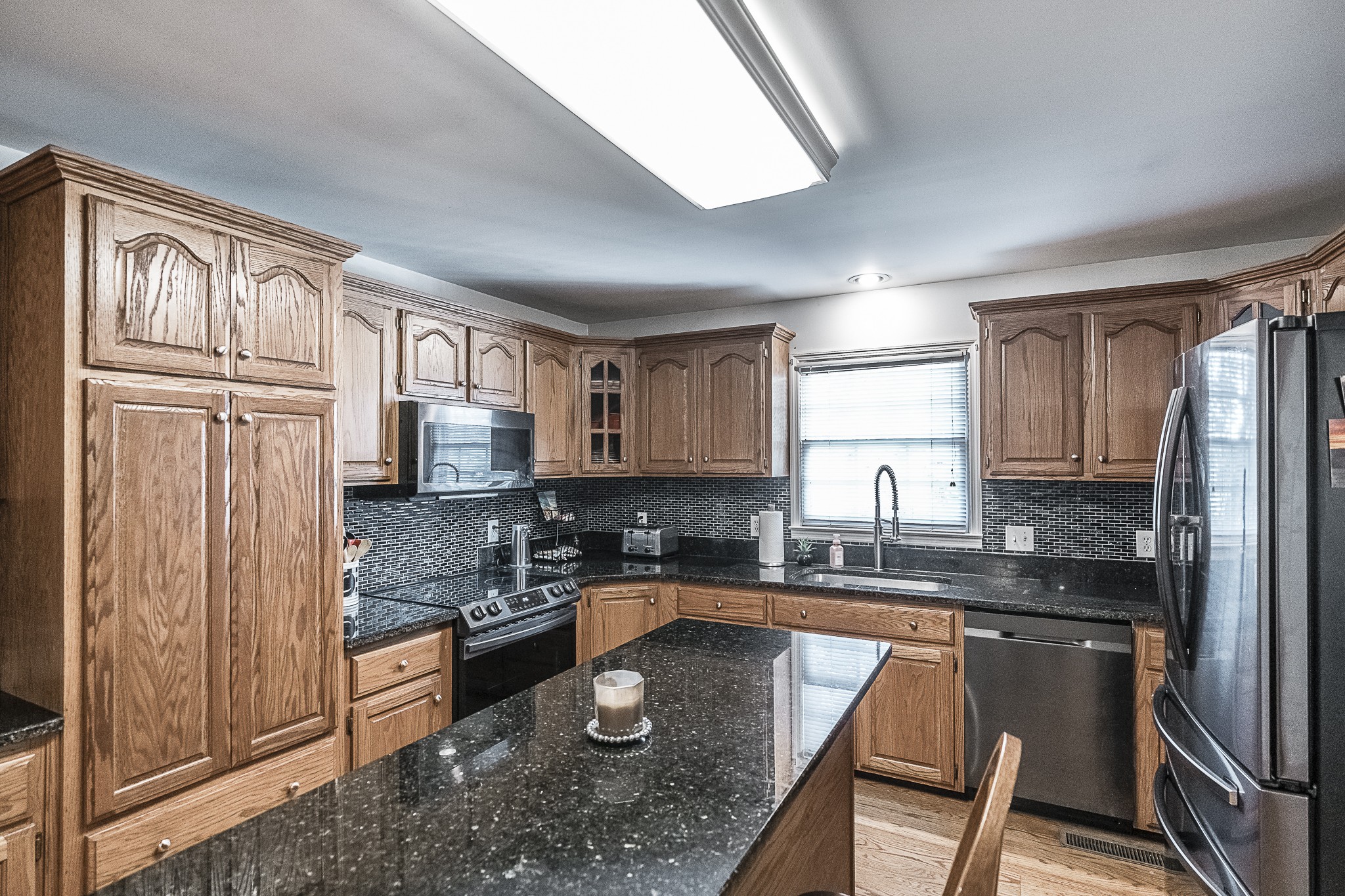 182 Calvert Ridge Road Westmoreland, TN 37186 - Photo 6 of 50 a kitchen with granite countertop stainless steel appliances a sink a stove a refrigerator cabinets and a window
