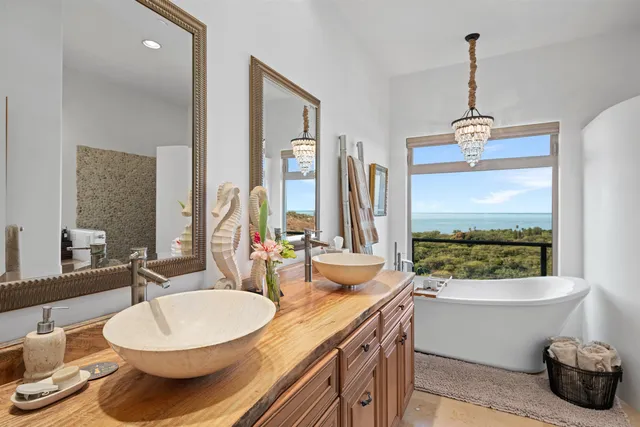 a bathroom with a granite countertop sink and a large mirror