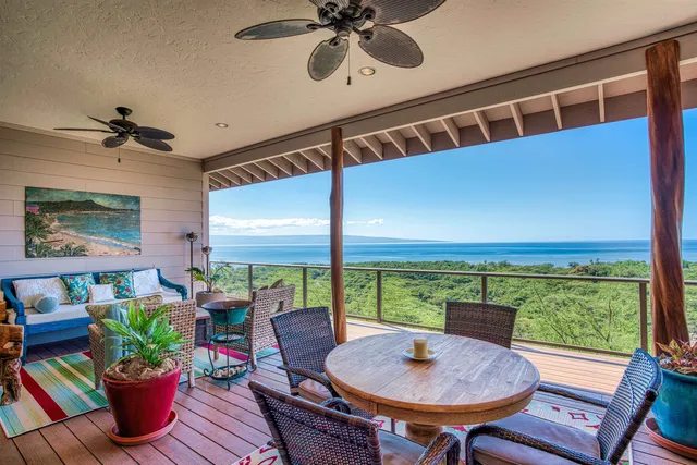 a balcony with furniture and a potted plant