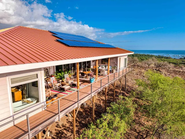 a view of a patio with table and chairs under an umbrella