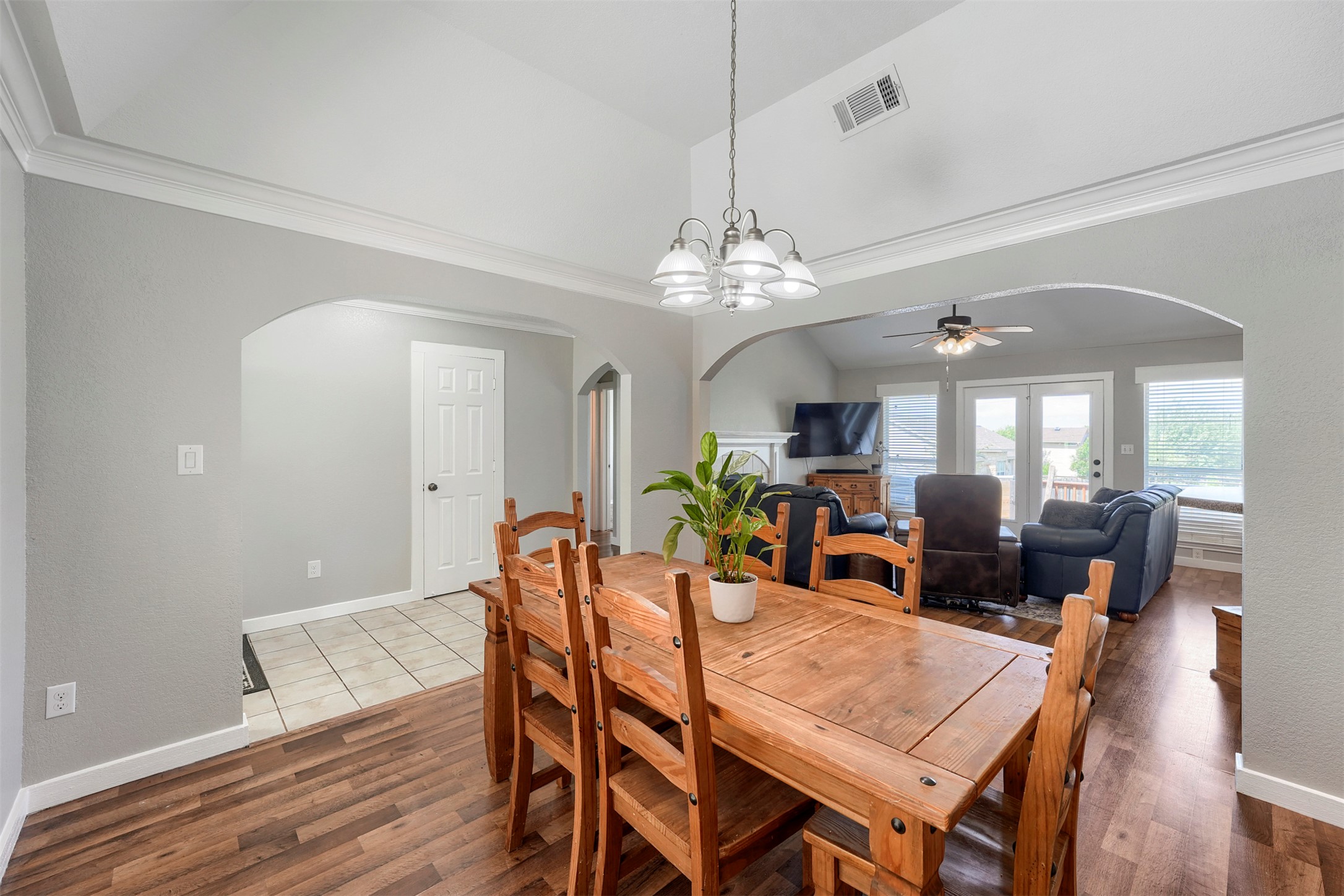 1105 2nd Street Jarrell, TX 76537 - Photo 8 of 27 A well-lit dining area features crown molding, wood flooring, and a ceiling-mounted light fixture.