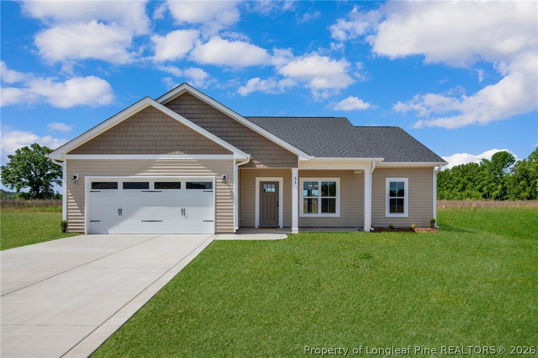 141 Libby Lane Raeford, NC 28376 - Photo 1 of 28 a front view of a house with a yard and trees
