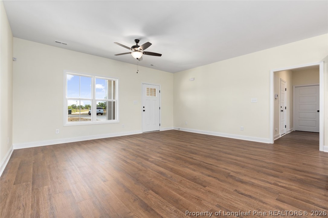 141 Libby Lane Raeford, NC 28376 - Photo 17 of 28 a view of an empty room with a window and wooden floor