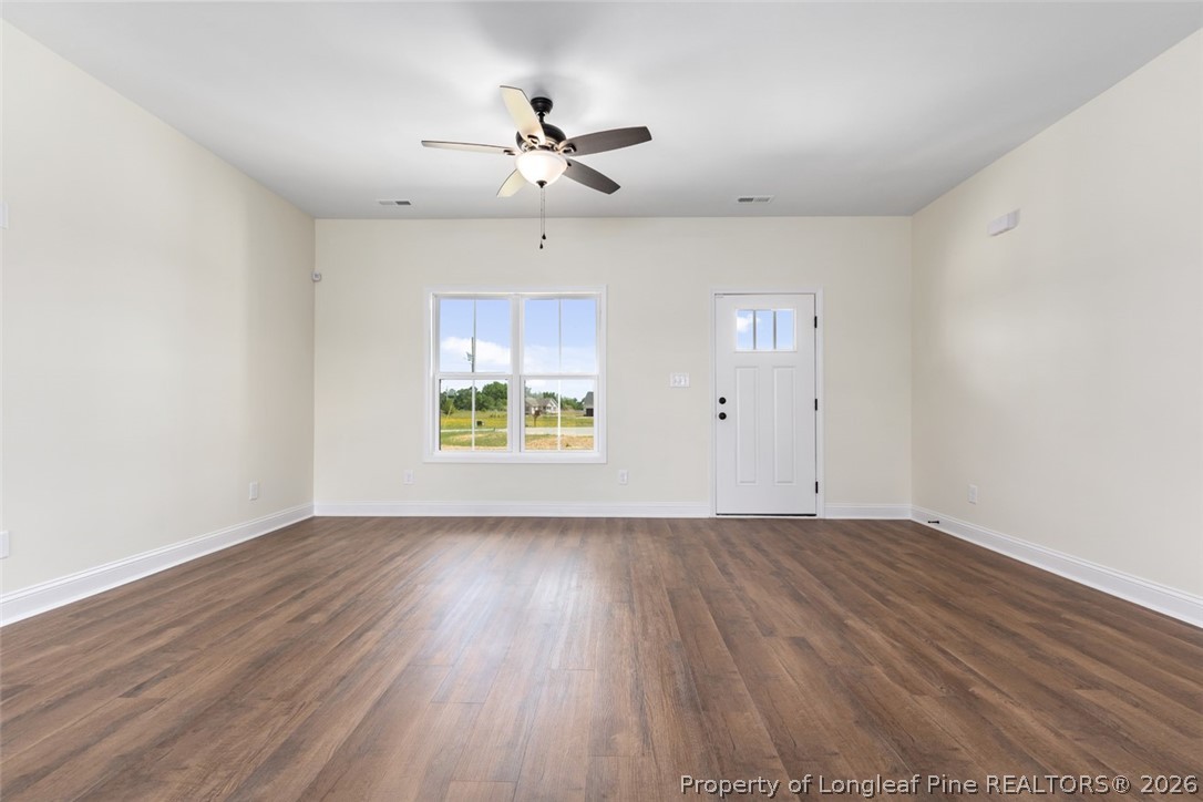 141 Libby Lane Raeford, NC 28376 - Photo 27 of 28 a view of an empty room with wooden floor and a window