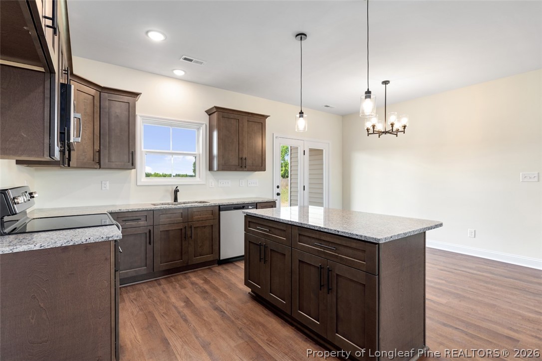 141 Libby Lane Raeford, NC 28376 - Photo 9 of 28 a kitchen with stainless steel appliances granite countertop a sink a stove and a wooden floors