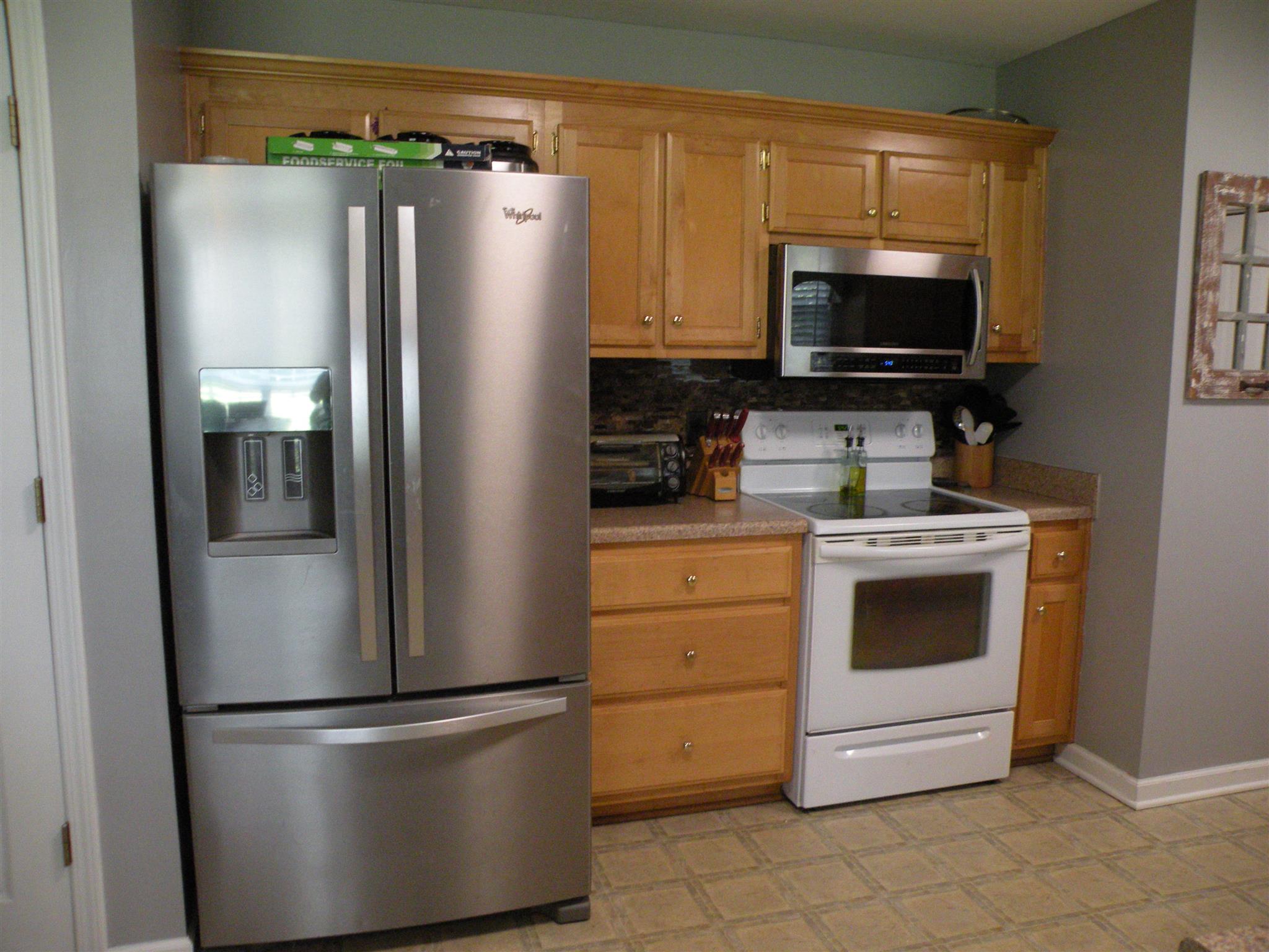 183 Lear Road Portland, TN 37148 - Photo 16 of 30 a white refrigerator freezer and a stove sitting inside of a kitchen