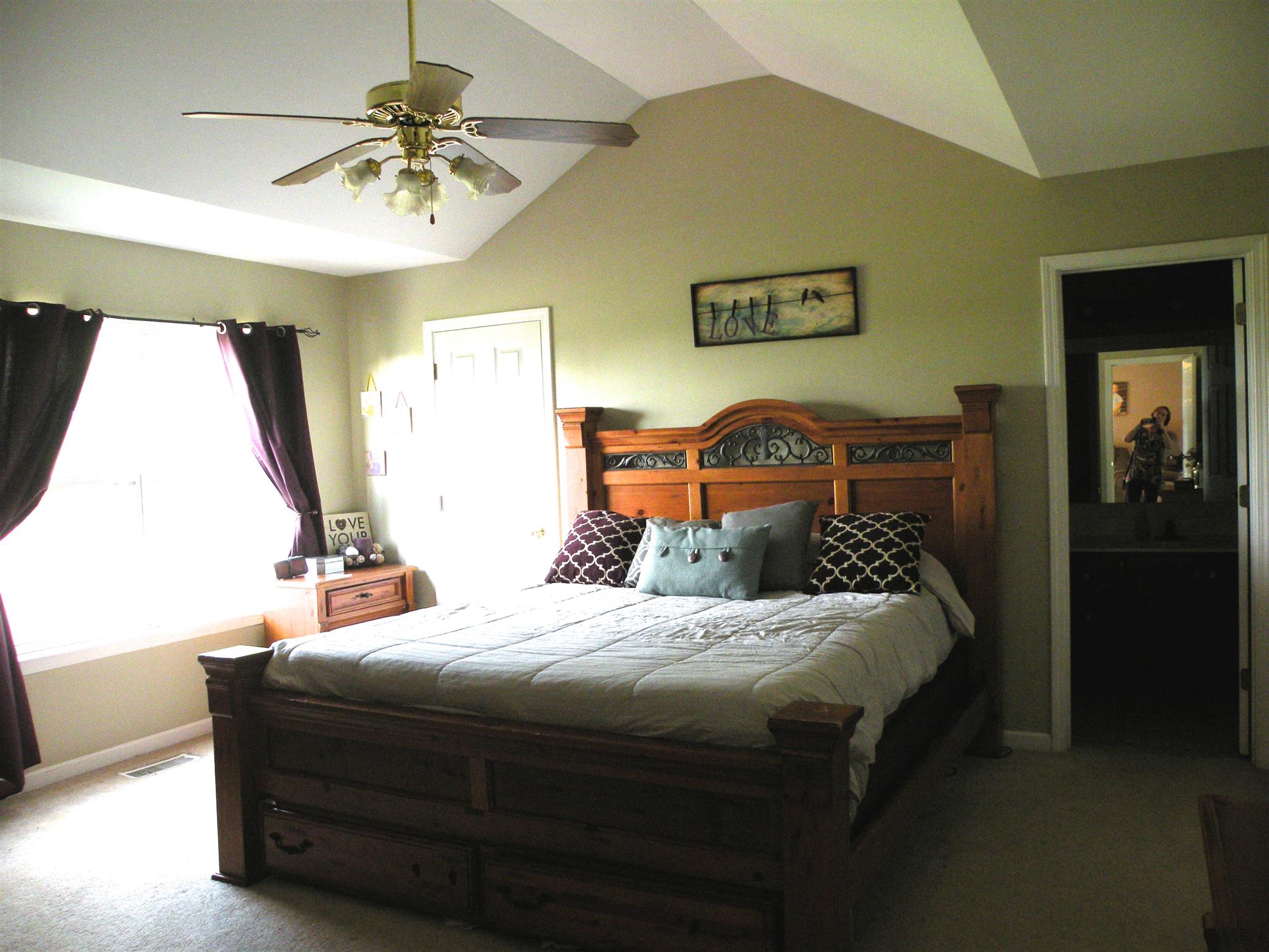183 Lear Road Portland, TN 37148 - Photo 17 of 30 a bedroom with a bed and a chandelier