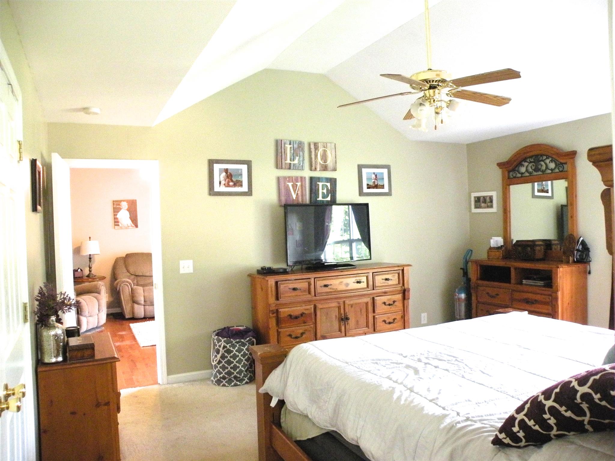 183 Lear Road Portland, TN 37148 - Photo 18 of 30 a bedroom with a bed and a chandelier