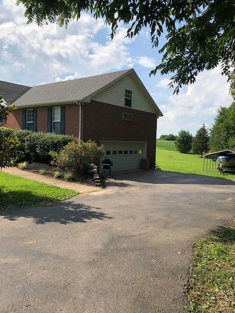 183 Lear Road Portland, TN 37148 - Photo 28 of 30 a front view of a house with a yard and garage