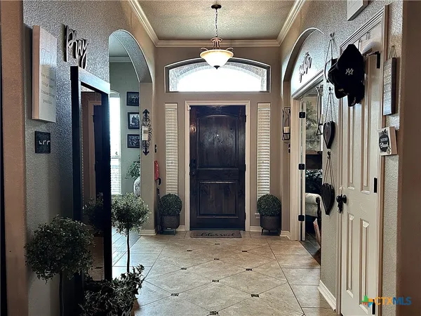 a view of a dining room with furniture large window chandelier