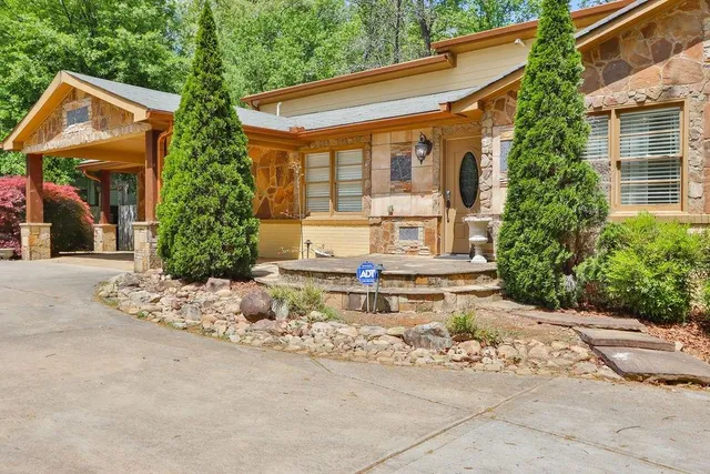 a living room with furniture a fireplace and a large window