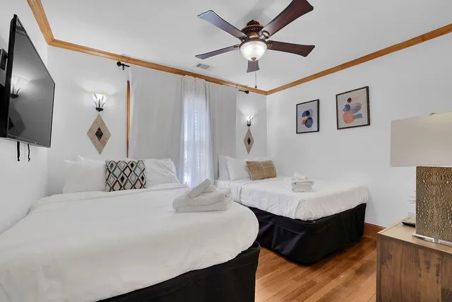 a spacious bathroom with a double vanity sink a mirror and a bathtub