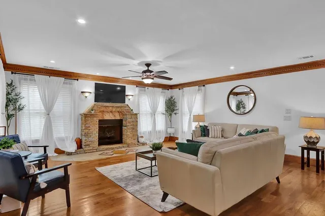 a kitchen with stainless steel appliances kitchen island granite countertop a refrigerator and a stove top oven