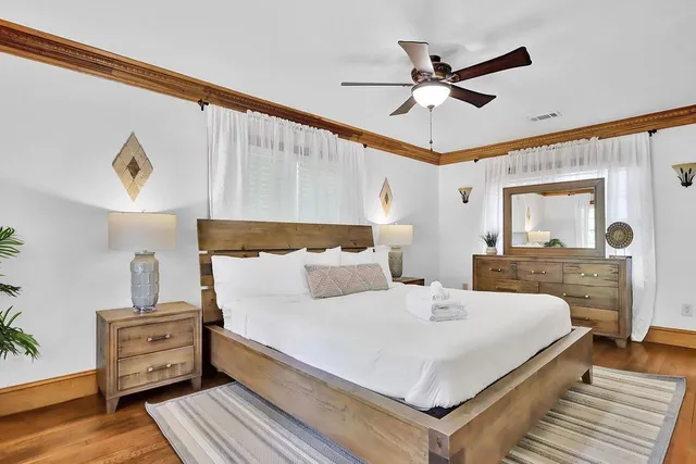 a bedroom with a large bed and a flat screen tv