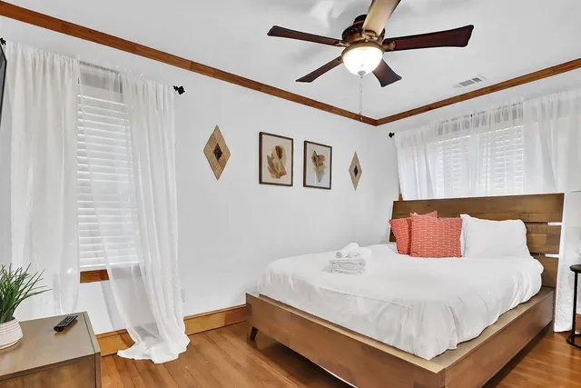 a bedroom with a bed and a chandelier