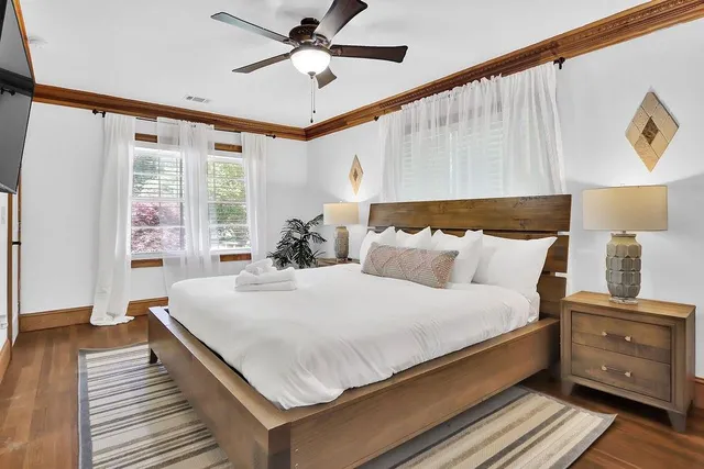 a bedroom with a bed and ceiling fan