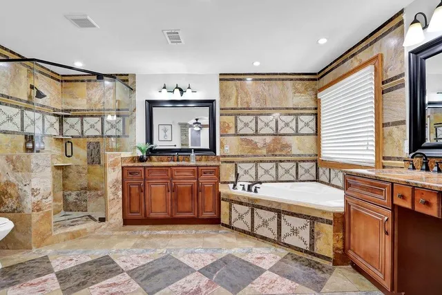 a bathroom with a sink toilet a mirror and bathtub