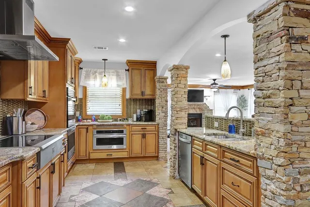 a living room with fireplace furniture and a flat screen tv