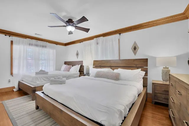 a kitchen with stainless steel appliances granite countertop a stove a refrigerator and a dining table with wooden floor