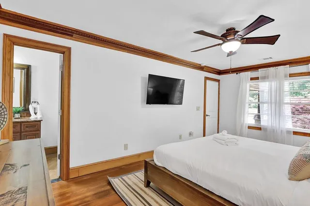 a bedroom with a bed and a flat screen tv